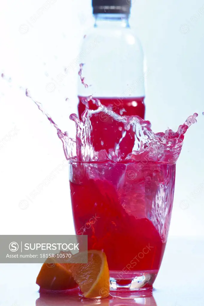 Bottle behind a glas with healthy drink