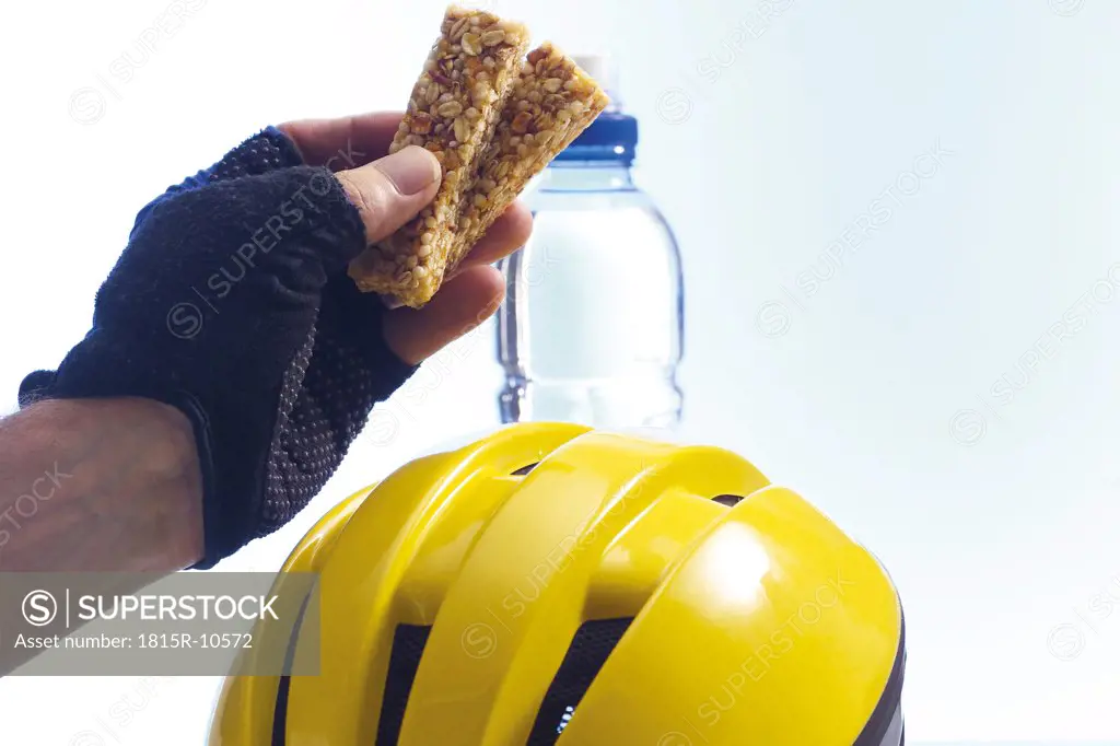 biker holding a granola-bar