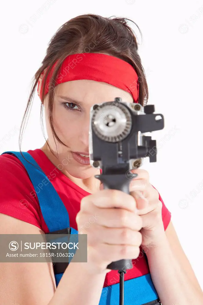 Young woman holding electric drill, portrait