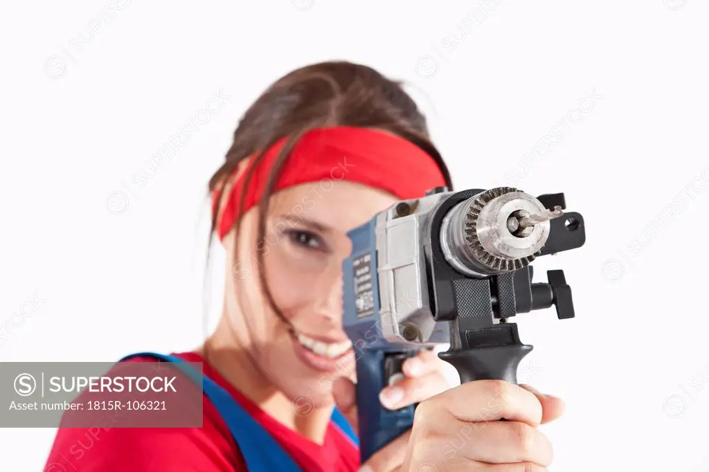 Young woman holding electric drill, portrait