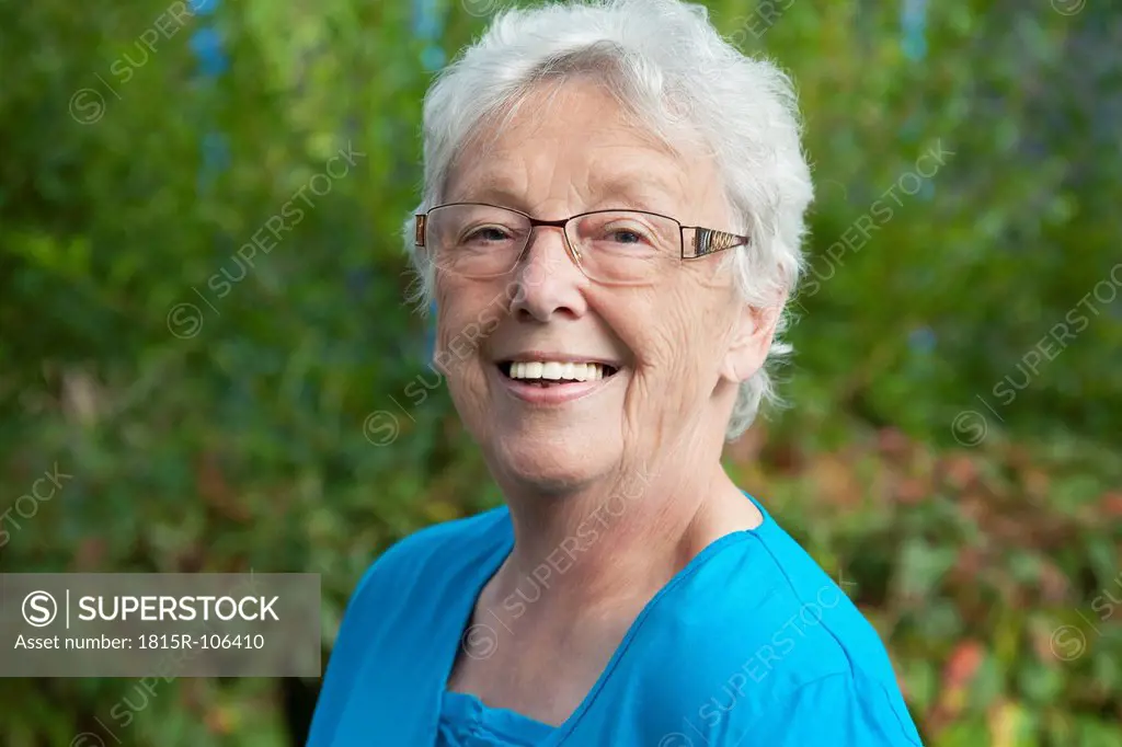 Germany, Bavaria, Huglfing, Senior woman in garden, smiling, portrait