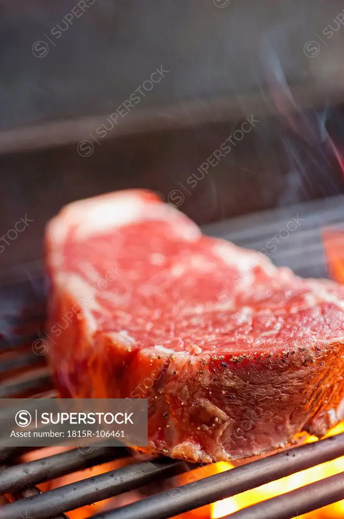 USA, Texas, Grilling rib eye steak, close up