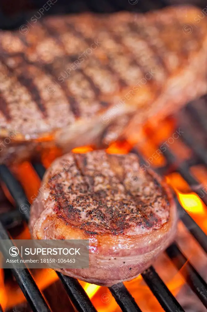 USA, Texas, Bacon wrapped rib eye steak on barbecue grill