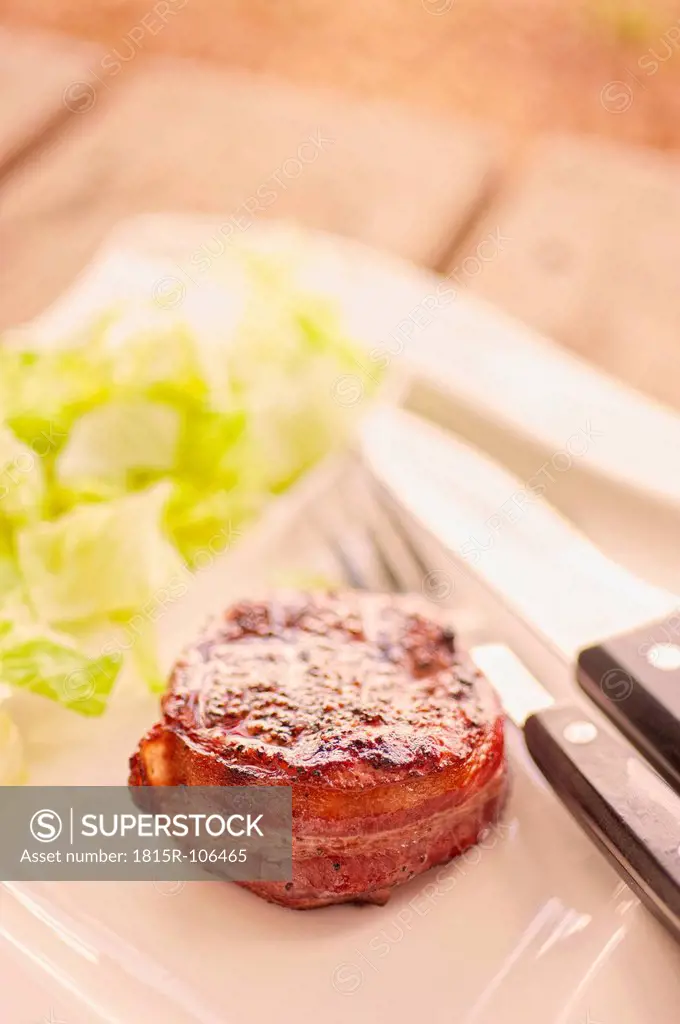 Grilled bacon wrapped with lettuce on plate