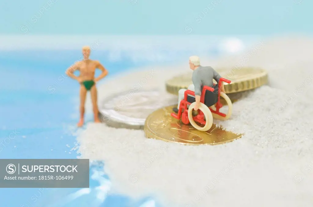 Figurines patient sitting on wheelchair with euro coin at beach