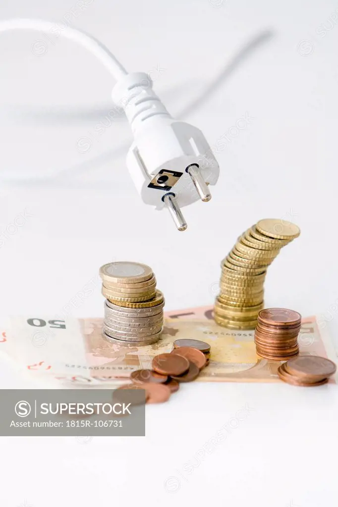 Electric cable flying above Euro coins and bills on white background