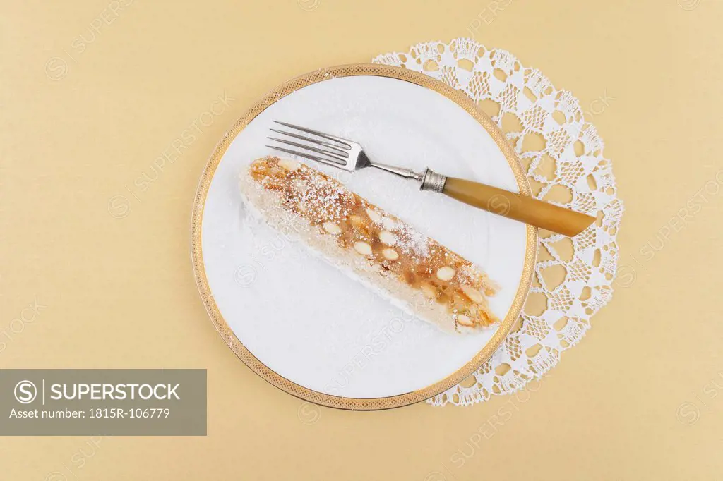 Slice of panforte with fork on porcelain plate