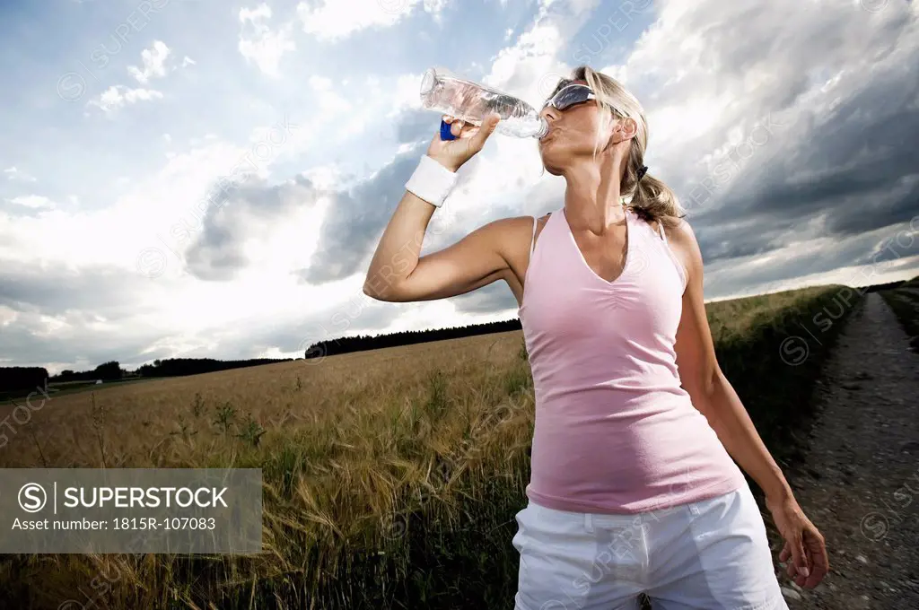 Germany, Bavaria, Mature woman drinking water