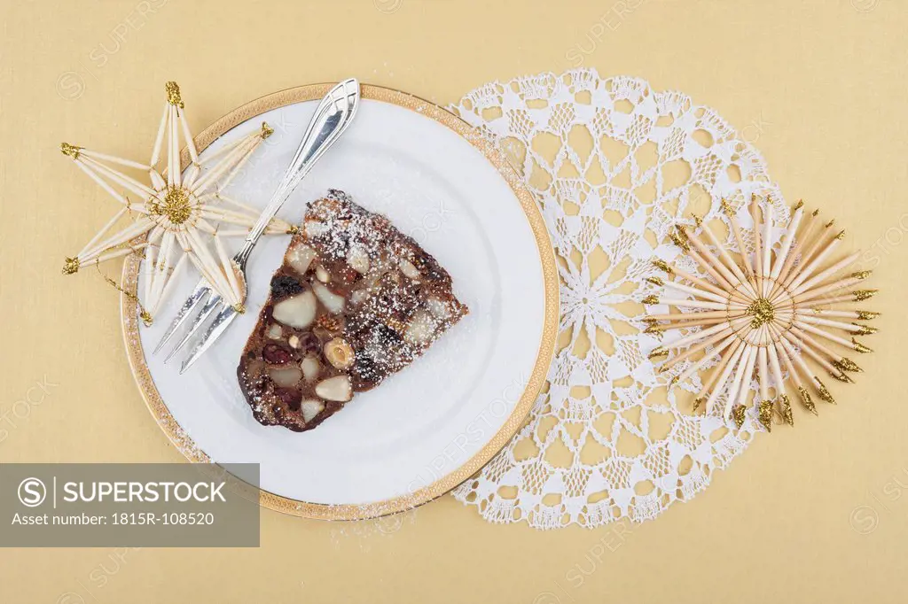 Plate of Christmas fruit cake slice with straw star