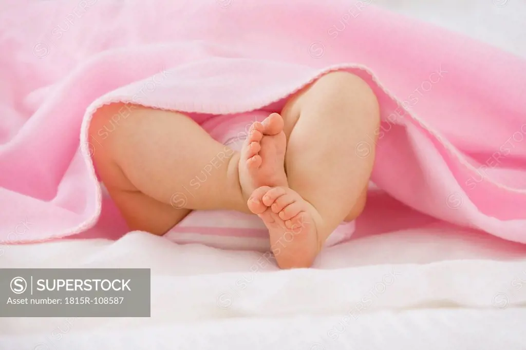 Baby girl lying on bed