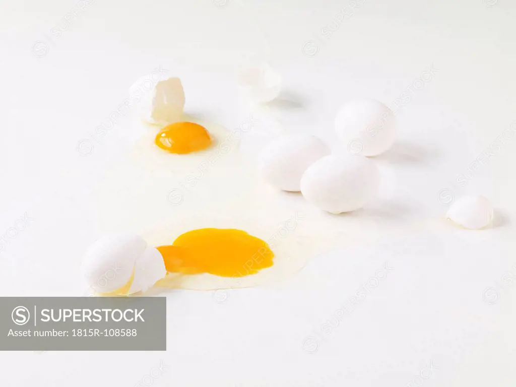 Broken eggs on white background