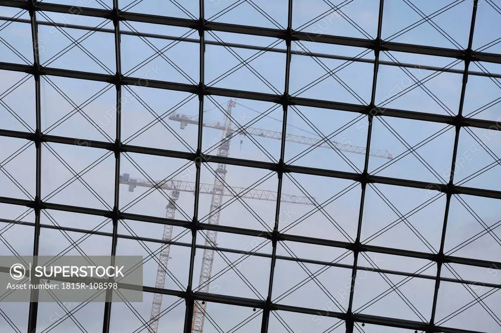 Germany, Berlin, Criss cross ceiling and construction cranes in background
