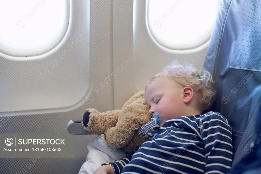 Germany, Boy sleeping in plane