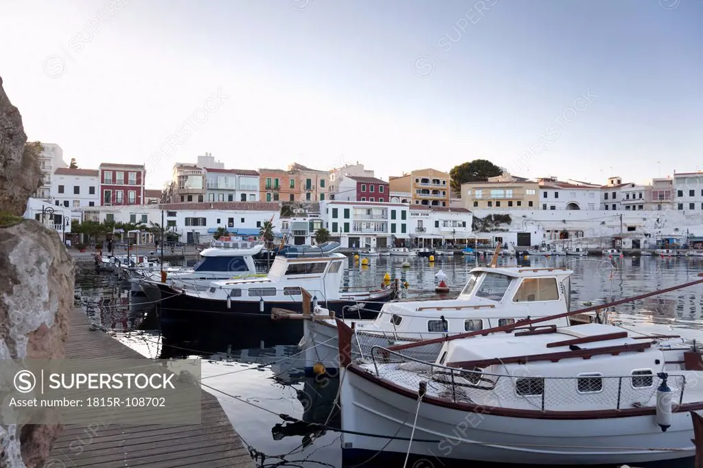 Spain, Menorca, View of harbour and old town of Es Castell in evening light