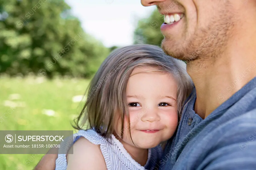 Gemany, Cologne, Father and daughter smiling, close up