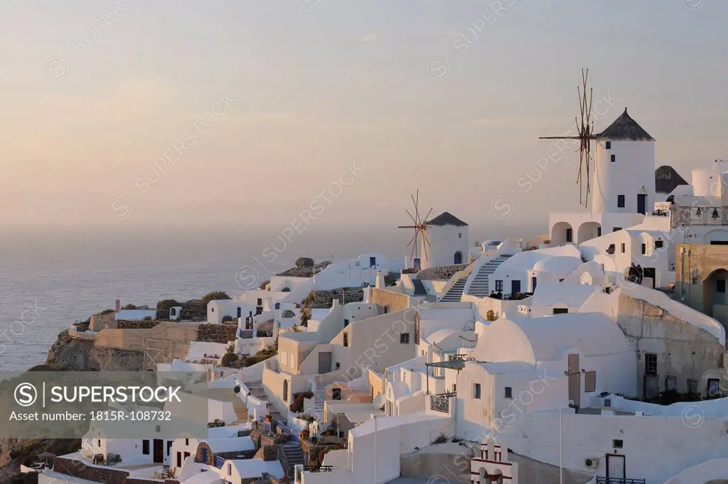 Greece, View of Oia village with traditional Greek windmills at Santorini