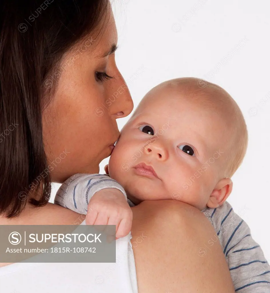 Mother kissing baby boy, close up