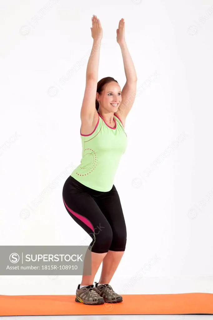 Young woman stretching arms up