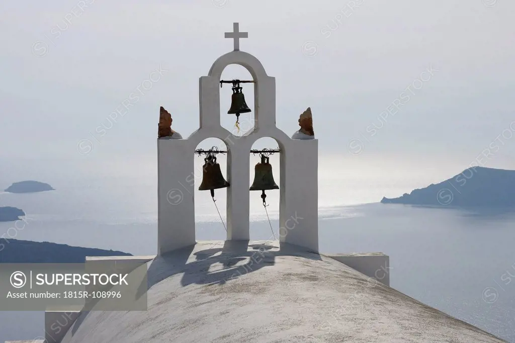 Greece, Bell tower of whitewashed church in Imerovigli, sea in background at Santorini