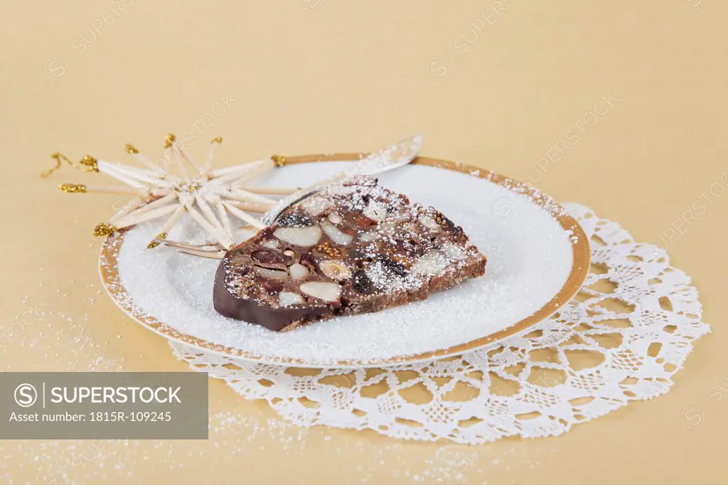 Plate of Christmas fruit cake slice with straw star