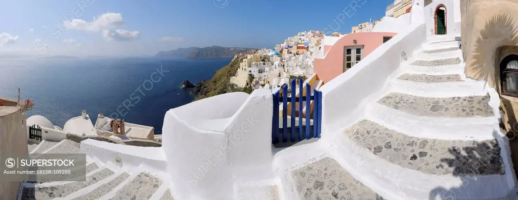 Greece, View of Oia village with cobbled path and blue gate at Santorini