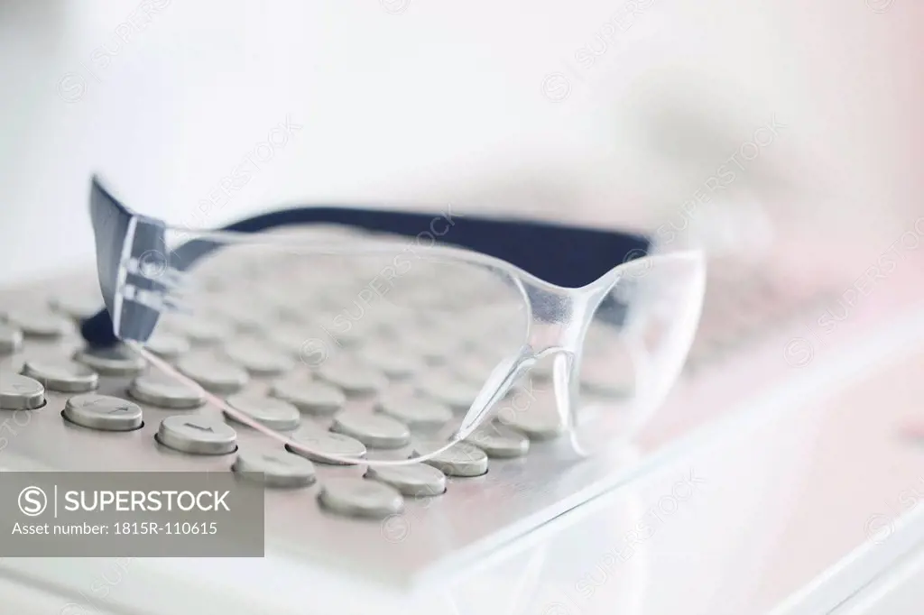 Germany, Safety glasses on keyboard in dental office