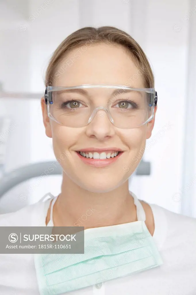 Germany, Dentist with safety glasses in dental office