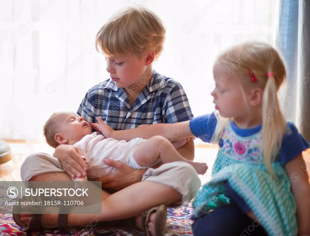 Germany, Bavaria, Children holding baby girl