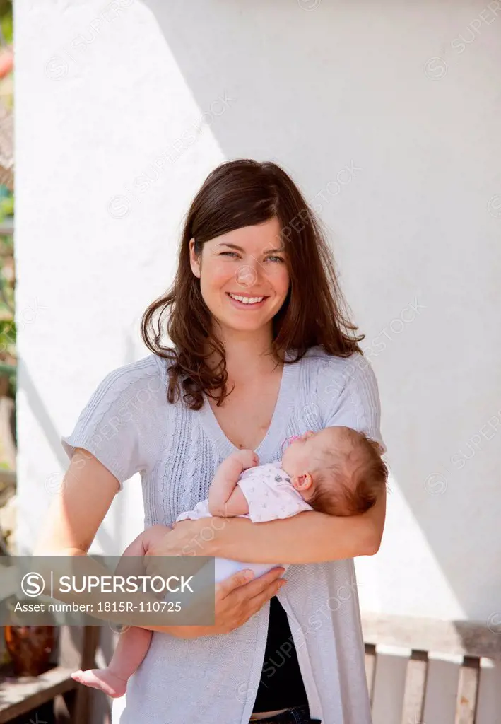 Germany, Bavaria, Mother holding baby girl