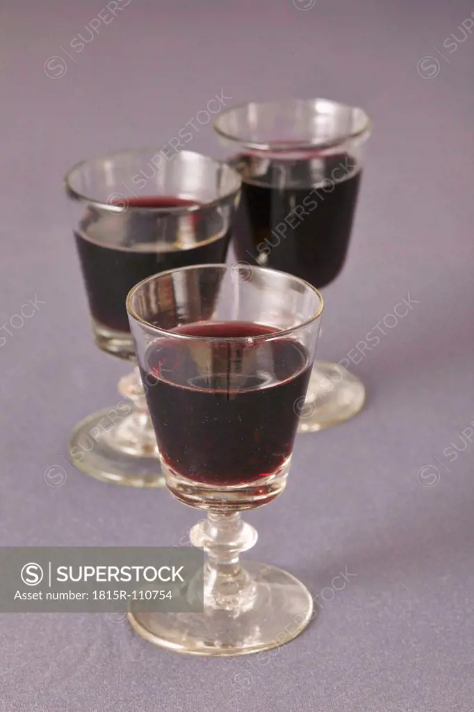 Wine glass with wine on gray background