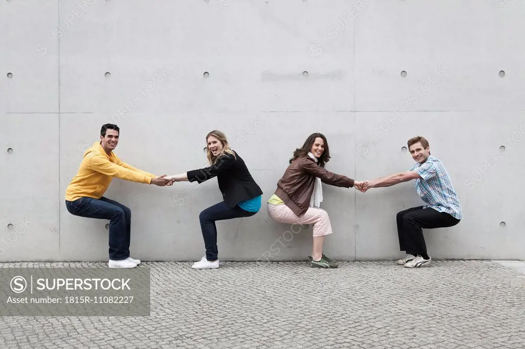 Germany, Berlin, Man and woman playing against wall