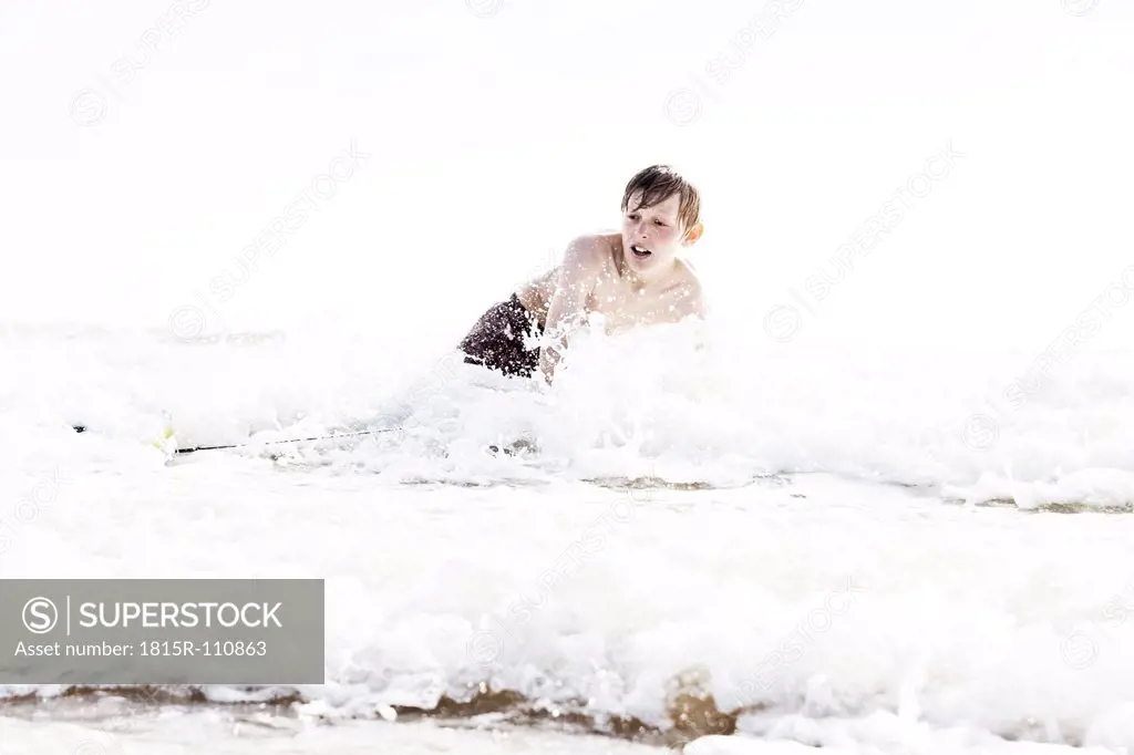 France, Boy surfing at Atlantic coast
