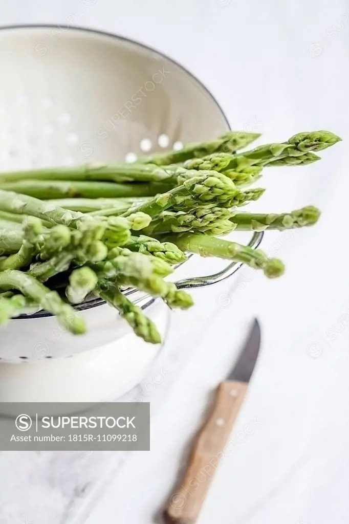 Green asparagus in colander