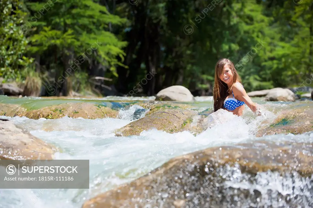 USA, Texas, Young woman enjoying in Frio river