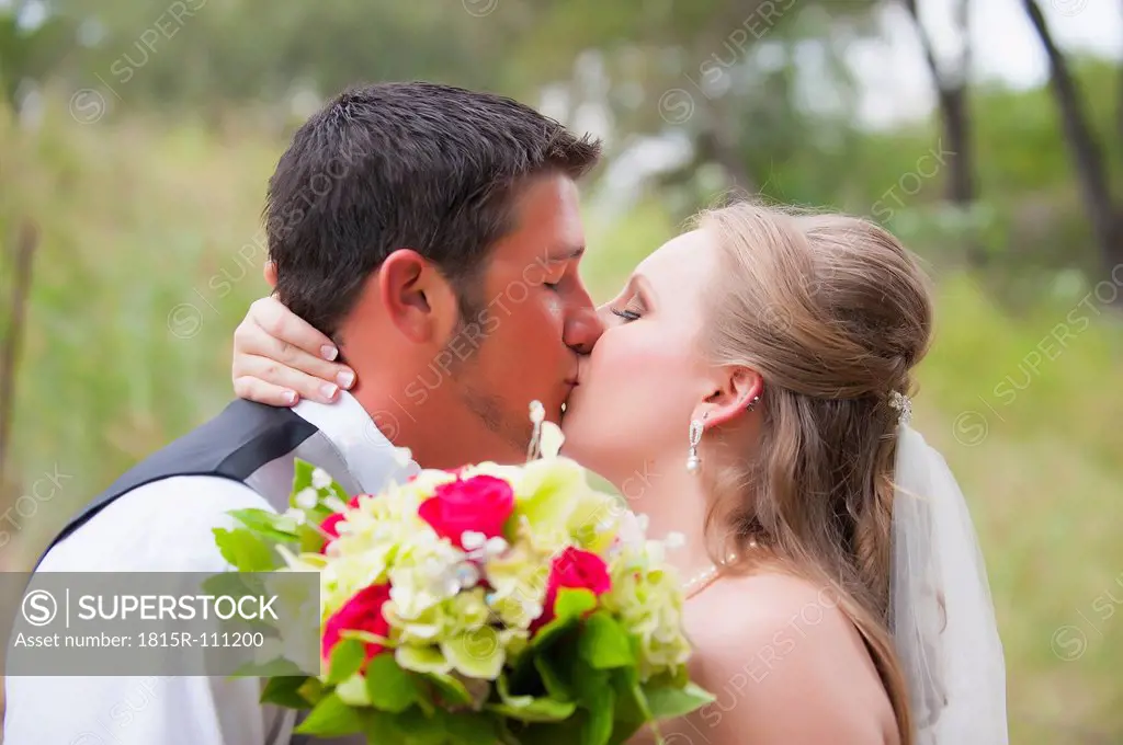 USA, Texas, Bride and groom kissing on wedding day