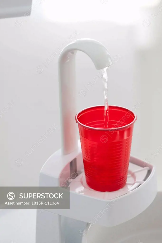 Germany, Water dispenser with disposable cup in dental office