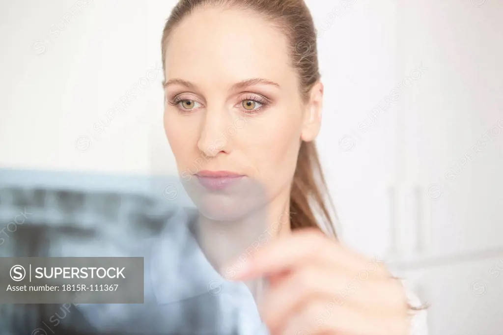 Germany, Dentist looking at dental x_rays