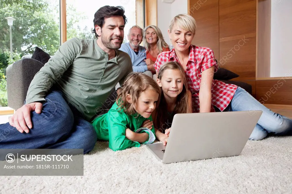 Germany, Bavaria, Nuremberg, Family using laptop in living room