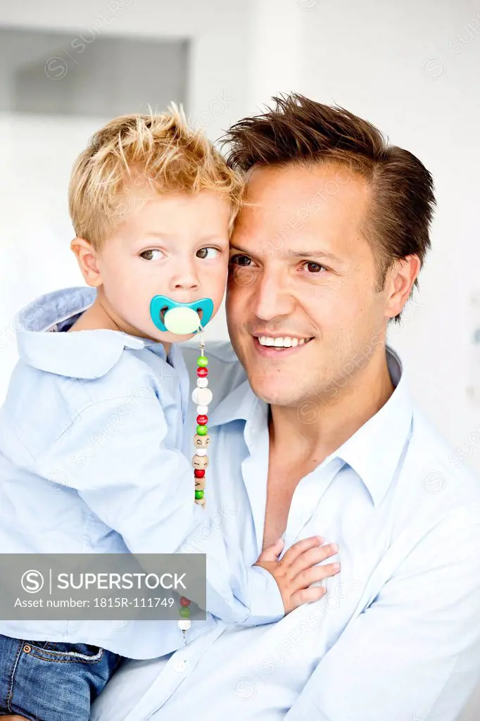 Germany, Son carrying pacifier, close_up