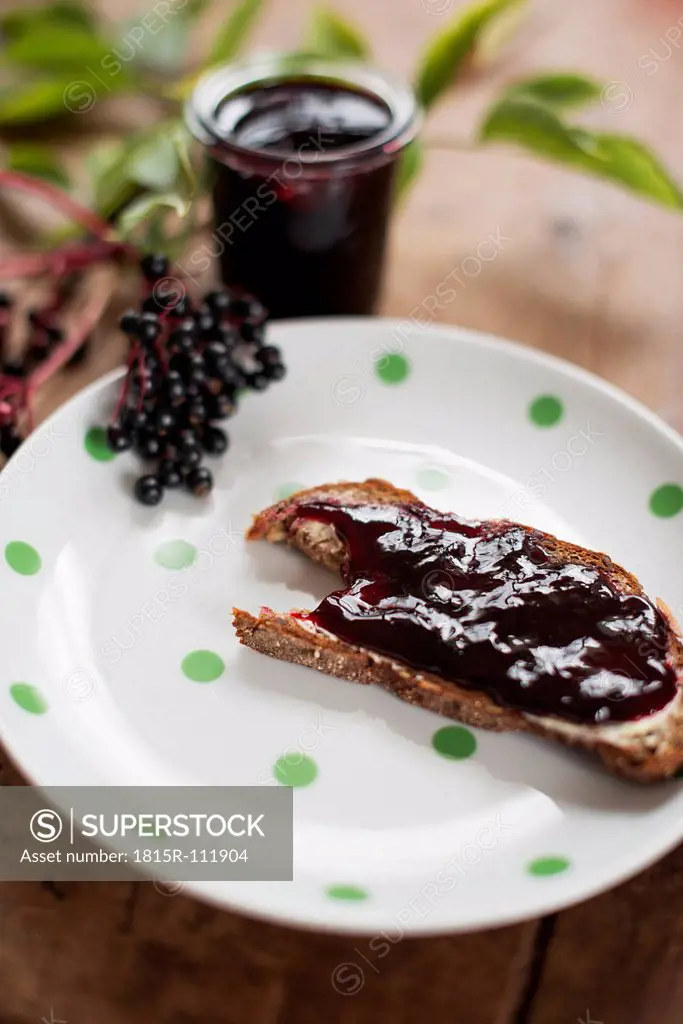 Slice of bread with elder jelly in plate