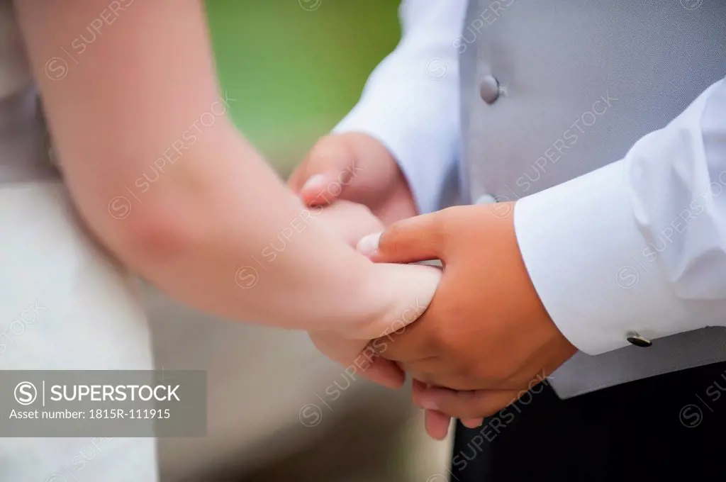 USA, Texas, Bride and groom holding hands, close up