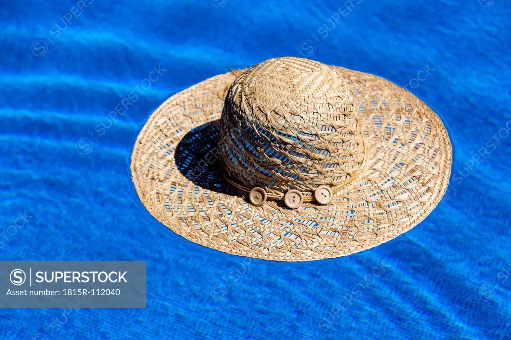 Austria, Linz, Sun hat floating in swimming pool