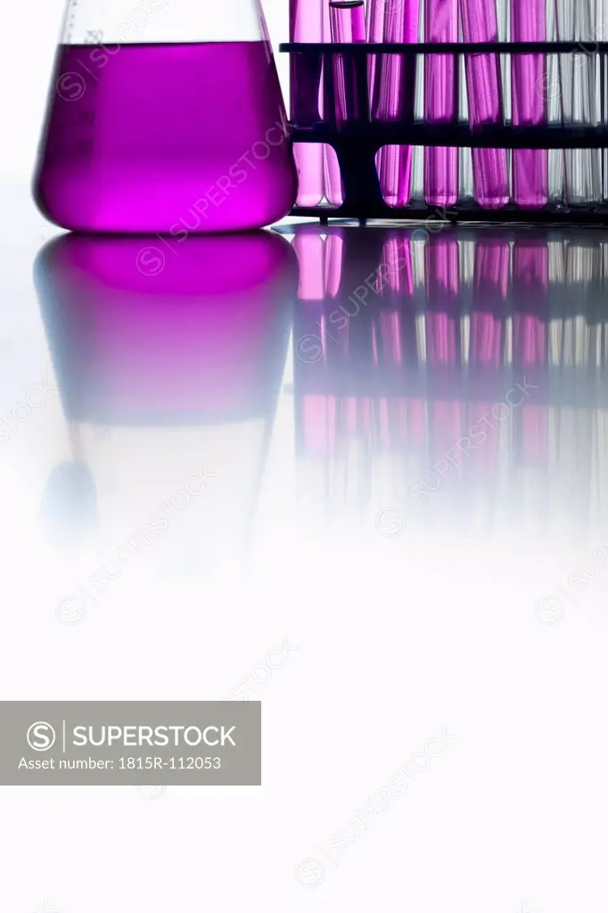 Test tubes and volumetric flask on white background, close up
