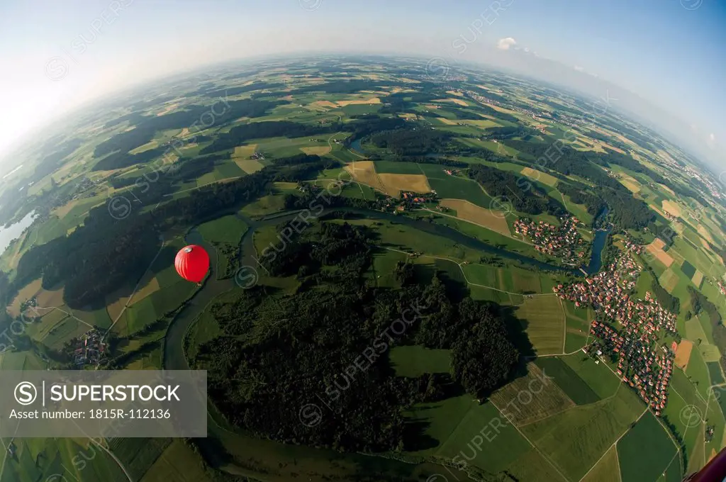 Germany, Bavaria, View of hot air balloon over pasture landscape
