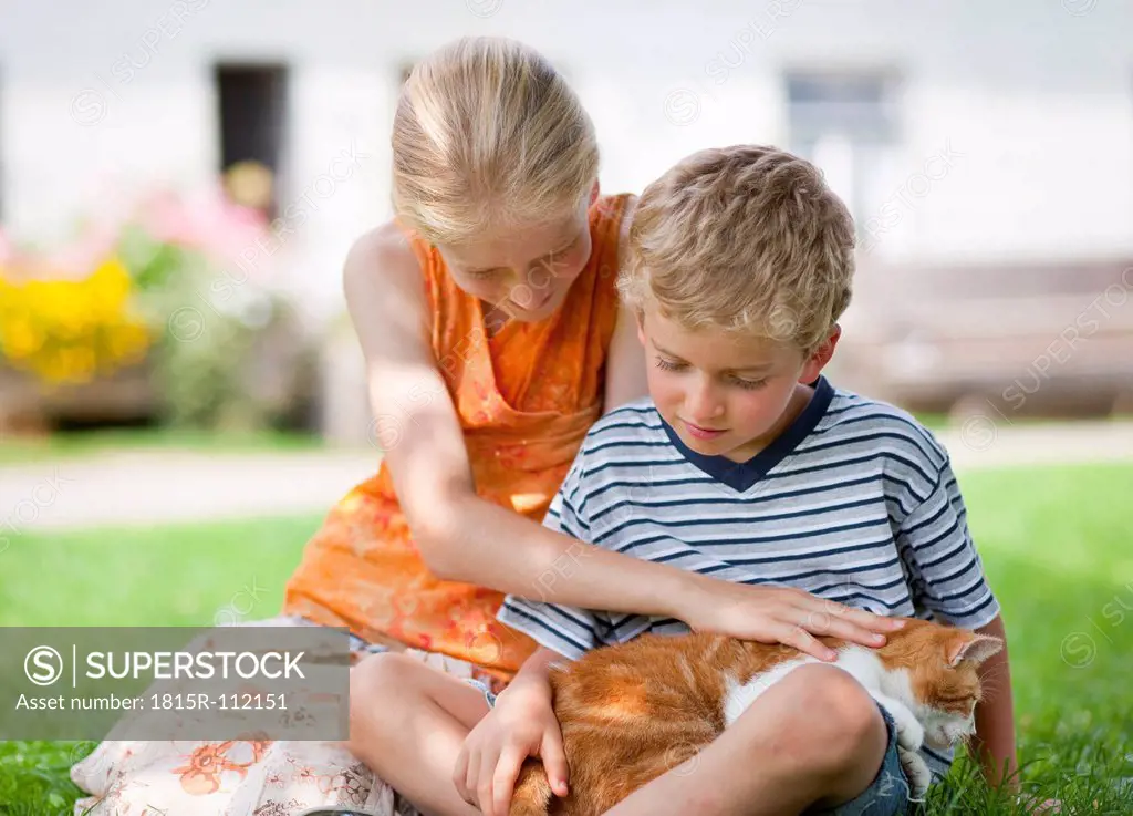 Germany, Bavaria, Boy and girl with cat on farm
