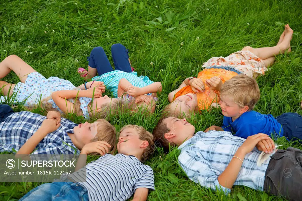 Germany, Bavaria, Group of children lying in meadow