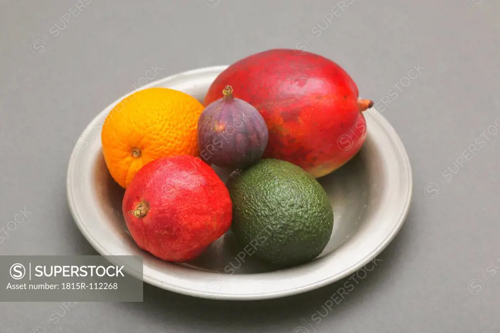 Plate of fruits on gray background