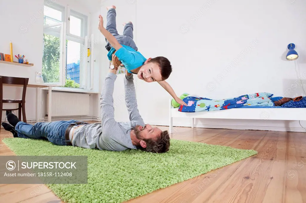 Germany, Berlin, Father holding son, smiling