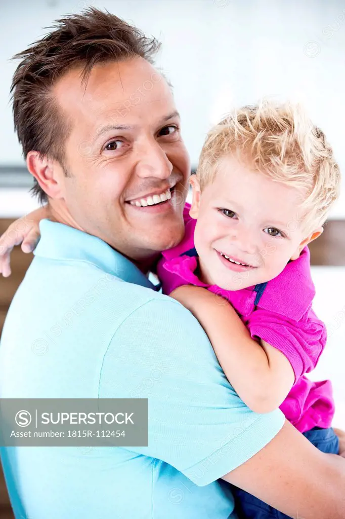 Germany, Father carrying son, smiling