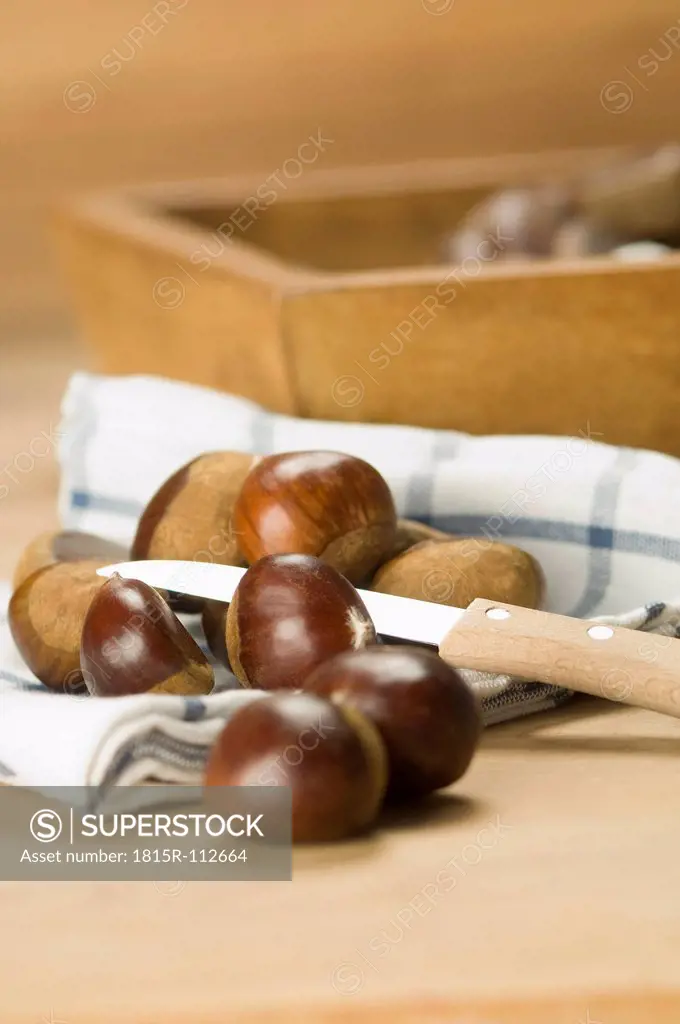 Close up of chestnuts on cloth with knife